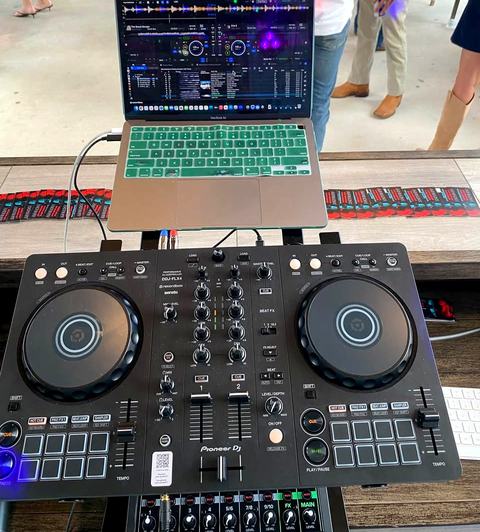 Pioneer DDJ-FLX4 controller and MacBook at the DJ booth